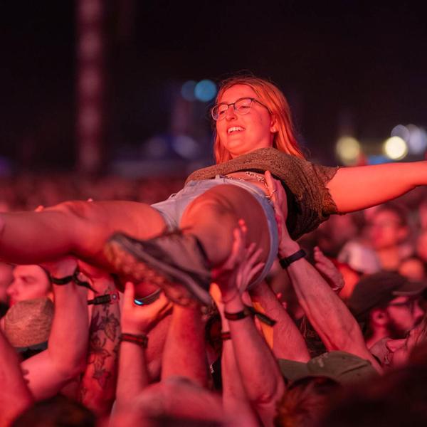 Crowdsurfen auf den tragenden Händen der Besucher