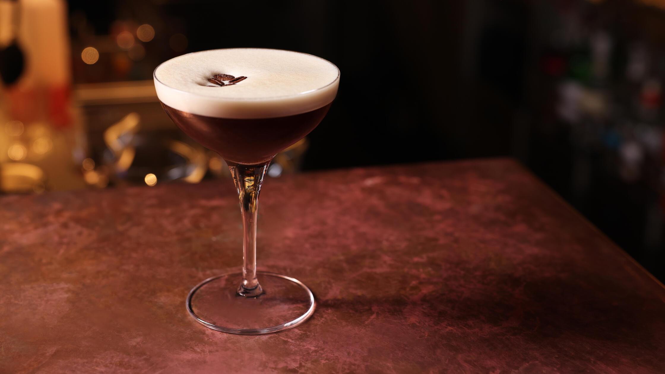 Glass of delicious Espresso Martini on bar counter