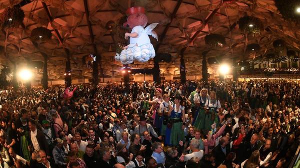 Bedienungen stehen auf den Tischen im Hofbräuzelt