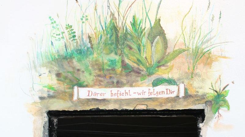 Über der kunstvoll eingeschlagenen Wand steht: "Dürer befiehl - wir folgen Dir"