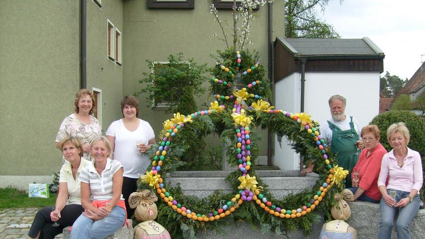 In Pruppach verbreiten am Osterbrunnen nicht nur die Eier Osterstimmung, sondern auch die beiden Strohhäschen.