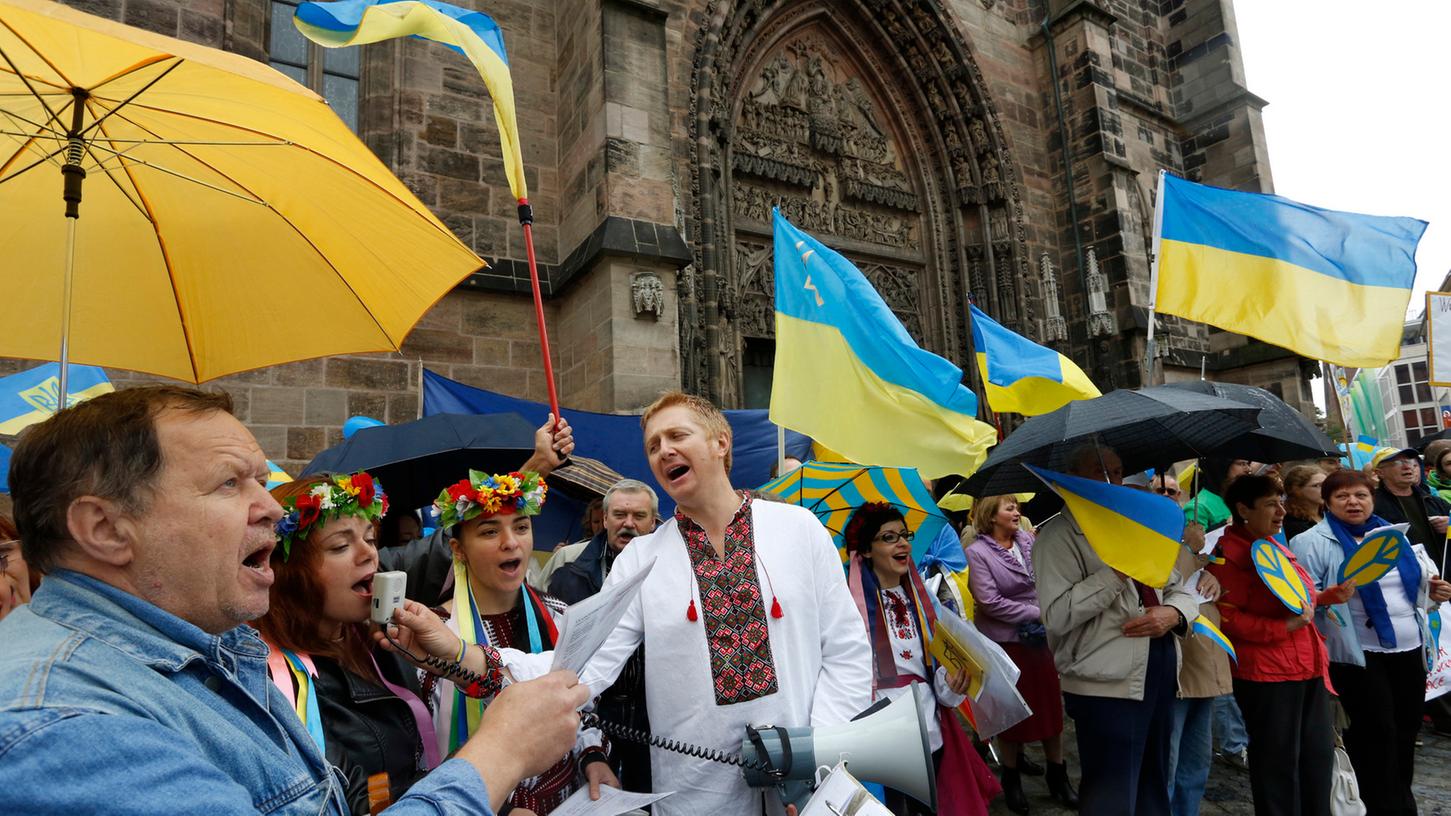 Gelb-Blaue Fahnen wehen bei einer Demonstration vor der Lorenzkirche: Auch in Nürnberg bewegt der unerklärte Krieg in der Ostukraine viele Menschen.