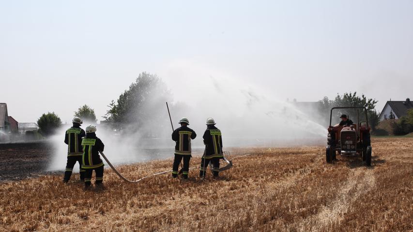 Gemeinsam mit den Landwirten löscht die Feuerwehr die Flammen. Die benachbarten Bauern ziehen Furchen um das verbrannte Land, um ein Ausbreiten des Feuers zu verhindern.