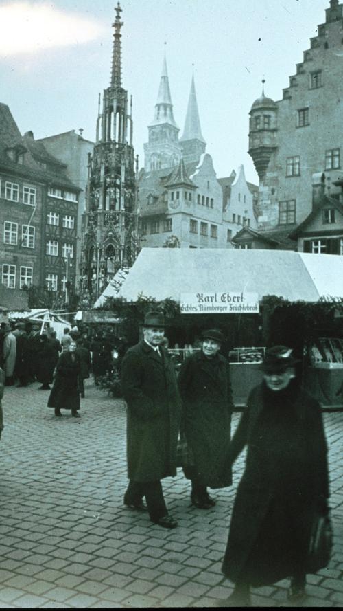 Diesem Bild zufolge war der Christkindlesmarkt im Jahr 1938 noch nicht ganz der Besuchermagnet, der er heute ist. Ganz ohne Gedrängel flanieren hier ein paar Besucher über den Hauptmarkt.