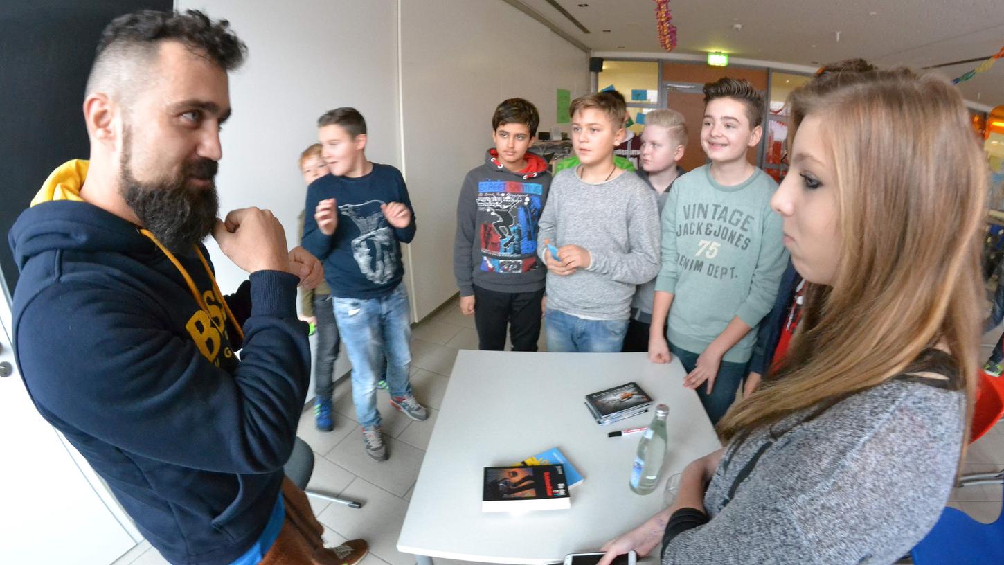 Ünsal Arik, umringt von Schülern. Ünsal Arik, umringt von Schülern.
