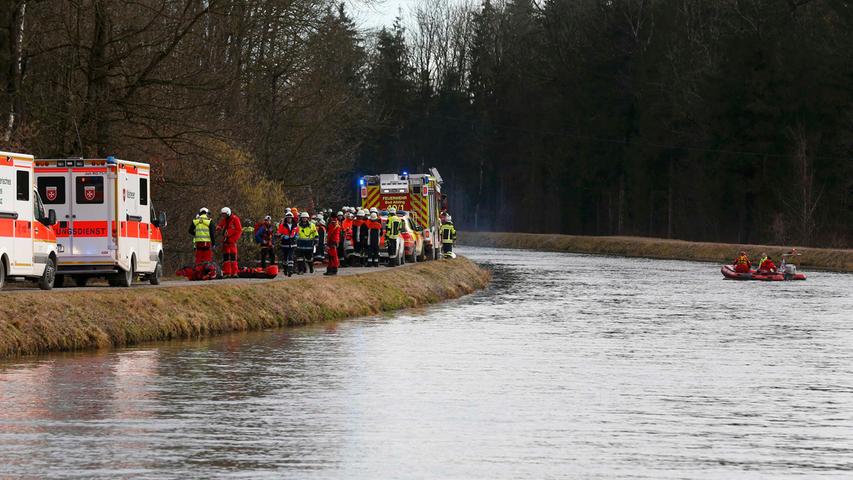 Members of emergency services stand by the river next to the two trains crash site near Bad Aibling in southwestern Germany, February 9, 2016. Several people died after two trains collided in the southern German state of Bavaria on Tuesday, a police spokesman said, adding about 100 people were also injured. REUTERS/Michael Dalder