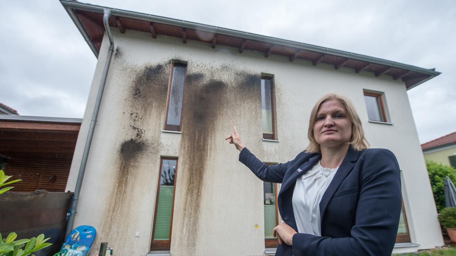 Die AfD-Vorsitzende des Kreisverbands Deggendorf Katrin Ebner-Steiner zeigt auf ihr beschädigtes Haus in Metten.