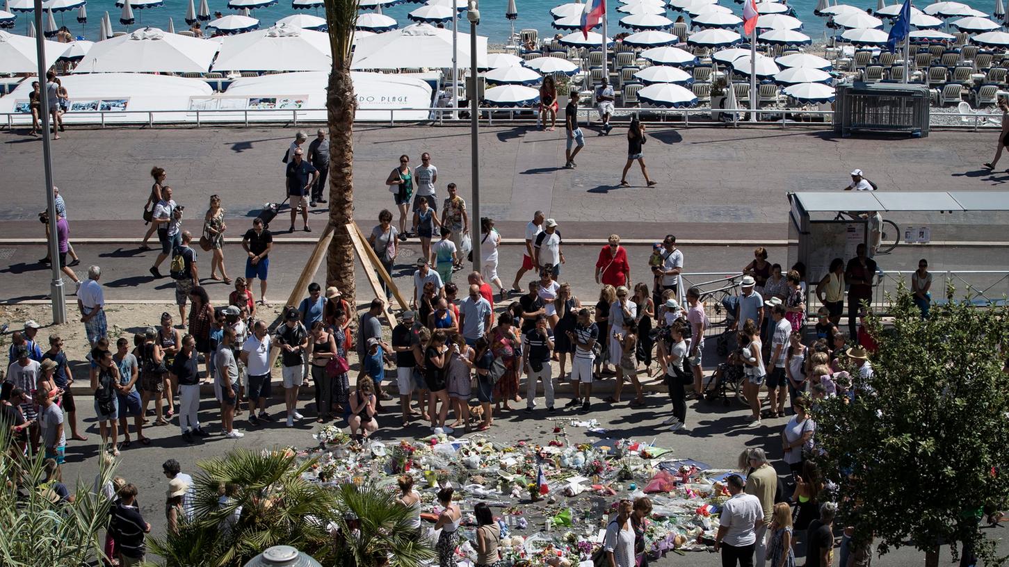Menschen versammeln sich an der Promenade des Anglais in Nizza und gedenken der Toten.