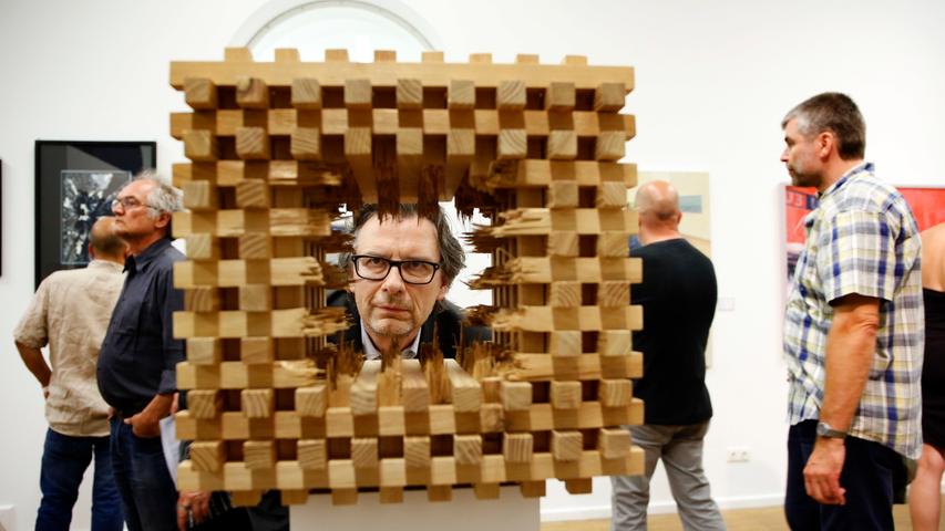Ein Betrachter wagt sich an Peter Helmstetters Holzskulptur "Kubus V" heran. Die eingereichten Objekte der Künstler sind im Rahmen der Ausstellung im Kunsthaus bis zum 11. September zu sehen.