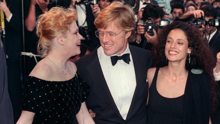 Großer Auftritt für die Hollywood-Stars: Robert Redford mit Melanie Griffith (li.) und Sonia Braga 1988 in Cannes, wo er für seine zweiten Regie-Arbeit, das sozialkritische Dram "Milagro - Der Krieg im Bohnenfeld", gefeiert wurde.