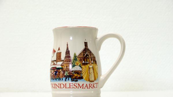 Vom Motiv, genau wie von der Form, ähnelte die Tasse des Vorjahres 2015. Lediglich die Größen der einzelnen Komponenten waren anders. So wurde etwa das Christkind deutlich größer abgebildet.