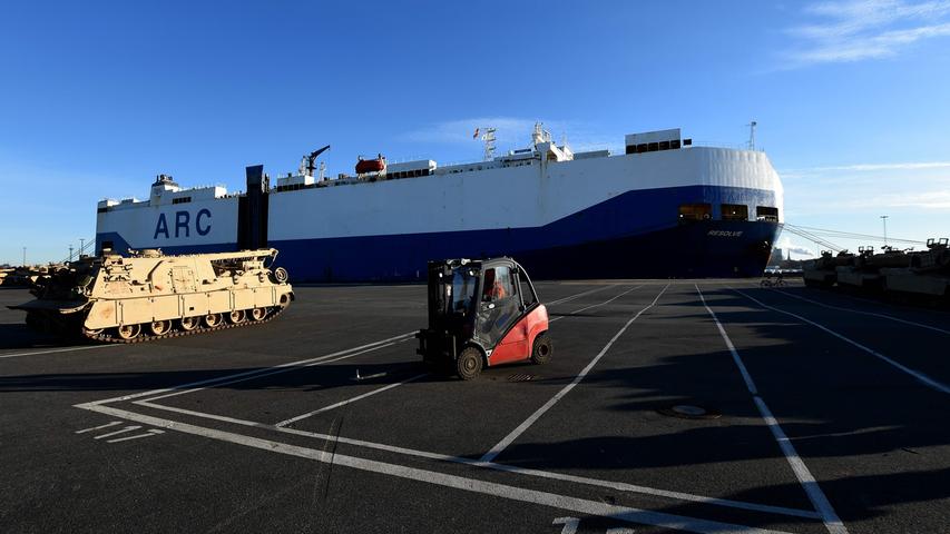 US military vehicles are unloaded from a transport ship in the harbour in Bremerhaven, northwestern Germany, on January 6, 2017..4,000 US soldiers and about 2,500 military vehicles are to be relocated to Poland and the Baltic states as part of the operation 