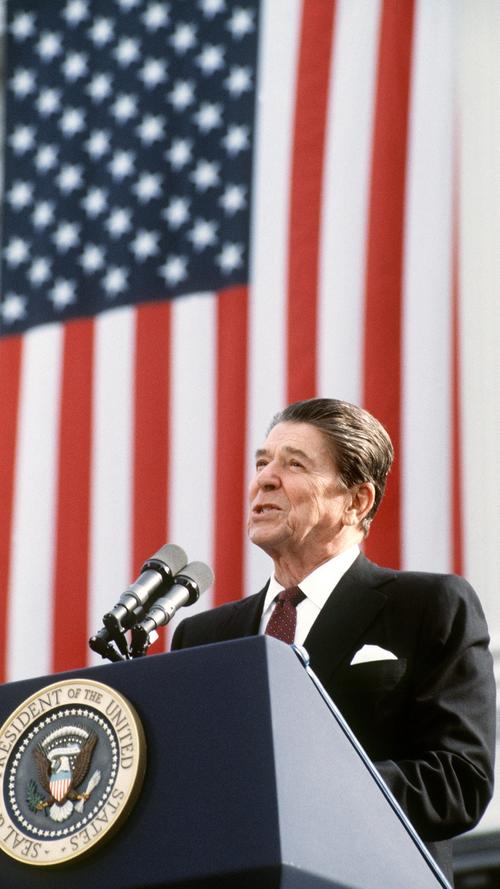 49 Wahlmännerstimmen für Präsident Carter. 489 Wahlmännerstimmen für Ronald Reagan. Ein Erdrutschsieg. Der "Große Kommunikator" hatte gewonnen. Mehr noch: Es gelang ihm - als erster Präsident, der seit Eisenhower wieder zwei volle Amtszeiten durchhielt - das Selbstverständnis der USA als "God's own country" und das Bild Amerikas als die Supermacht auf Erden aufzupolieren. Mit ihm an der Spitze schienen Nixon und Konsorten ein für allemal in die Vergangenheit verbannt. Dabei war Reagan eigentlich mehr Darsteller eines Präsidenten, denn de facto die oberste Verwaltungskraft seines Landes: Er regierte wie ein Senior-Vorstandsvorsitzender über einen Weltkonzern namens USA, hielt sich aus dem Polit-Alltag und Gesetzgebungsprozess heraus und wollte knapp formulierte Ergebnisse vorgelegt bekommen, über die er dann nur noch eine endgültige Entscheidung zu fällen hatte. Sein Auftreten und seine einnehmende Art strahlten über alles hinweg - von Steuersenkungen und Privatisierungswellen, die für mehr Ungleichheit sorgten, über rasant steigende Militäretats und unfassbare Haushaltsdefizite sowie die Aushöhlung des ohnehin schwachen Sozialstaats: Reagan und seiner Wirtschaftspolitik ("Reaganomics") konnte man alles verzeihen - mussten sich ja erst spätere Generationen mit den desaströsen Folgen quälen. Selbst die Iran-Contra-Affäre prallte an Reagan beinahe unbeschadet ab: Geld aus geheimen Waffenlieferungen an den Iran für einen rechten Staatsstreich in Nicaragua zu benutzen? Der einstige Film- und Fernsehschauspieler verkaufte es der US-Bevölkerung mit onkelhafter Unschuldsmine. Auch eine "konservative Revolution", die es so nie gab und höchstens mit säbelrasselnden Reden über die UdSSR als "Reich des Bösen" artikuliert wurde. Der im Innern bröckelnden Sowjetunion versetzte der dogmatische Anti-Kommunist mit einem neuen Wettrüsten den Todesstoß von außen. Die Linken und Linksliberalen verachten Ronald Reagan bis heute so sehr wie er von Republikanern und Konservativen vergöttert wird. Irgendwo dazwischen findet sich vielleicht der Mensch Ronald Reagan. Ein großer US-Präsident zweifellos - aber vor allem von der Statur her.