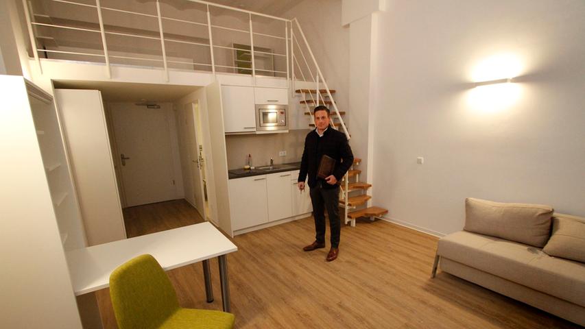 Im denkmalgeschützten Zollhof entstanden rund 90 Ein- und Zwei-Zimmer Apartments, die im Nu verkauft waren. Fertig möbliert, aber noch ohne Bewohner: Makler Benjamin Ascherl zeigt ein Ein-Zimmer-Apartment mit Galerie.