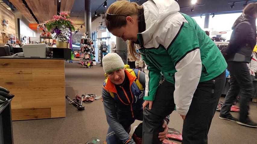 Vor dem Schneeschuhvergnügen steht die Anprobe im Sportgeschäft. Der Bergführer empfiehlt: Schuhe vor Ort auf die richtige Größe einstellen – das ist komfortabler als im Tiefschnee.