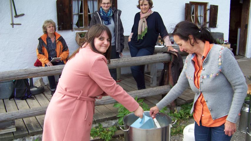 Katharina Kern (re.) zeigt wie's geht: Während die Milch erhitzt wird, gilt es, kräftig zu rühren. Und laufend die Temperatur zu messen.