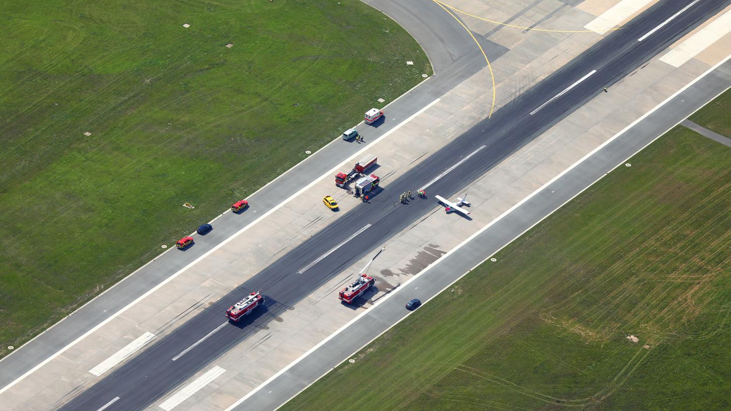Viel los auf der Landebahn: Mehrere Einsatzfahrzeuge von Feuerwehr und Polizei stehen bei der gelandeten Cessna.