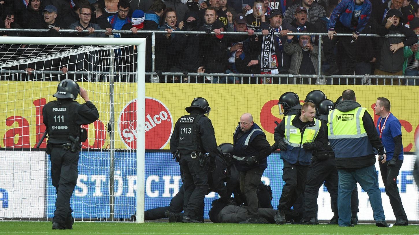 Etwa 25 Chaoten sorgten am Dienstagabend für einen Platzsturm. Nach dem Polizeieinsatz leiten DFB und DFL gegen Holstein Kiel nun ein Ermittlungsverfahren ein.