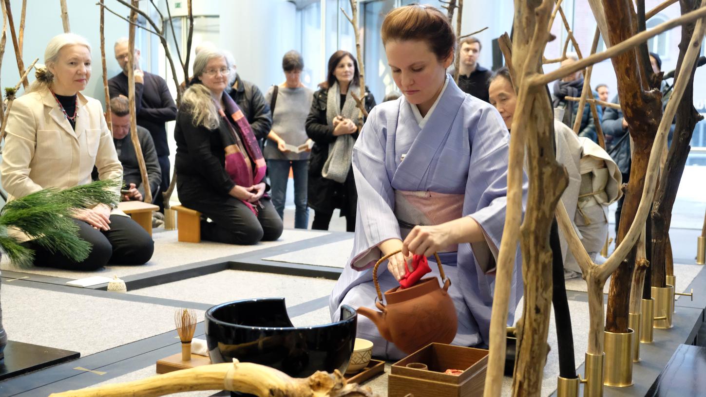Auf meditative Art und Weise führt die junge Frau die japanische Teezeremonie aus.
