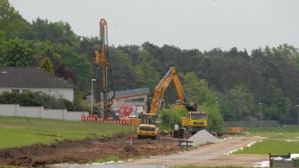 Durch das saftige Wiesengrün zieht sich ein braunes Band der Kanaltrasse Richtung Pumpstation. Daneben wurde eine provisorische Straße aus mobilen Elementen für die Baustellenfahrzeuge angelegt. Durch das saftige Wiesengrün zieht sich ein braunes Band der Kanaltrasse Richtung Pumpstation. Daneben wurde eine provisorische Straße aus mobilen Elementen für die Baustellenfahrzeuge angelegt.