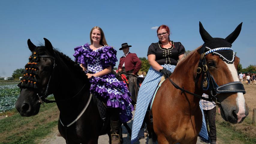 Diese Damen stehlen in ihren auffälligen Kleidern den Pferden fast die Show. Die Pferde kümmert es jedoch kaum, schließlich ist der Tag nach ihnen benannt.