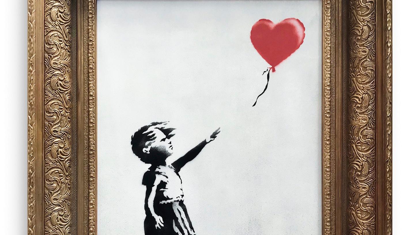 "Girl with Ballon" von Banksy, herausgegeben vom Auktionshaus Sothebys in London. Das Bild des Street-Art-Künstlers Banksy hat sich kurz nach seiner Versteigerung in London selbst zerstört.