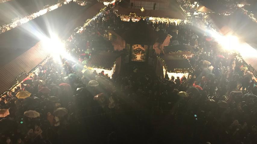 Mit großen bunten Schirmen versammelten sich die Besucher unter der Frauenkirche - alle mit dem Blick nach oben.