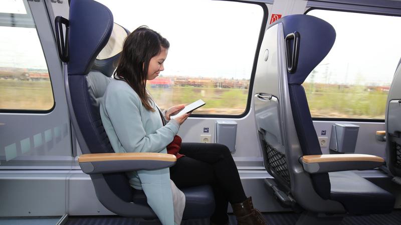 Eine junge Frau surft in einer Regionalbahn in Magdeburg im Internet nit ihrem Tablet-Computer.