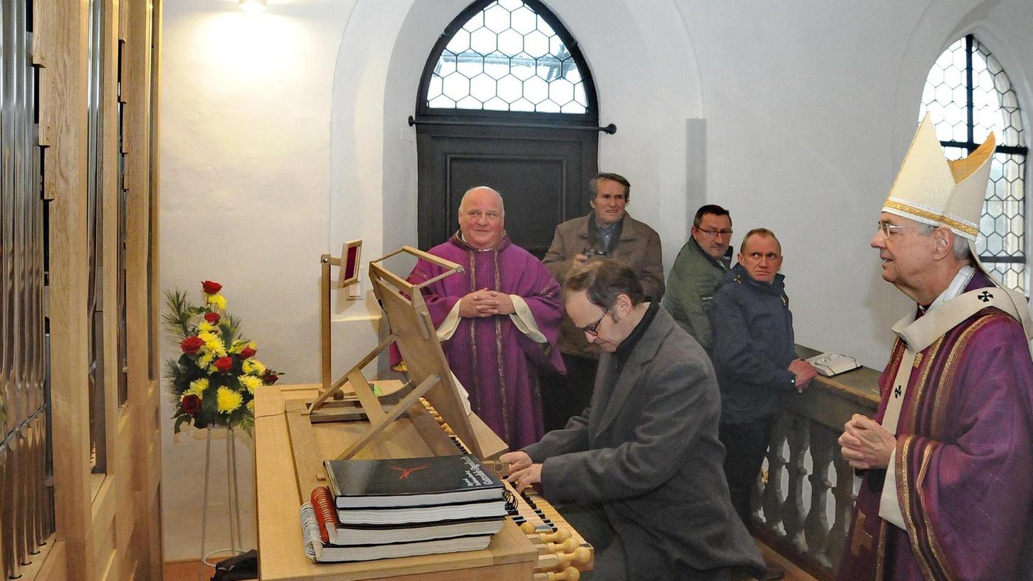 Auf dem Bild rechts Erzbischof Ludwig Schick, der wie seine Mithörer begeistert ist vom raumfüllenden Klang der neuen Orgel. Im violetten Gewand Diakon Norbert Naturski.
