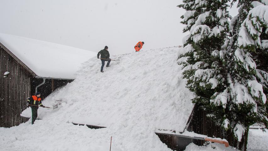 Im bayerischen Elisabethszell schaufelten Einsatzkräfte den Schnee von einem Dach...