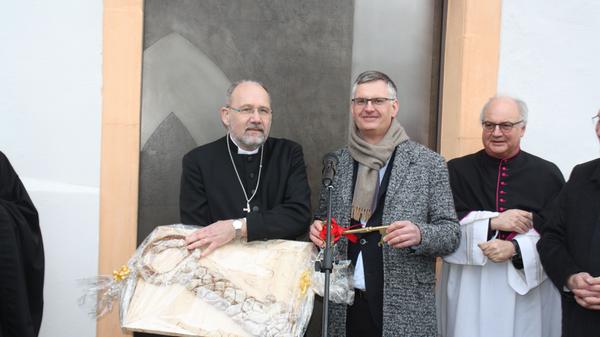 Noch ist die Klosterpforte geschlossen, doch Architekt Hans-Heinrich Häffner aus Ellingen hat für Hausherrn Dekan Klaus Kuhn den Schlüssel dabei. Neben einem Exemplar aus Metall überreichte er auch einen aus Brotteig gebackenen Schlüssel samt dem obligatorischen Salz.