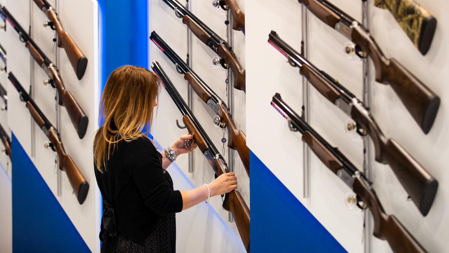 Eine Besucherin betrachtet Jagdgewehre auf der Fachmesse für Jagd, Schießsport, Outdoor und Sicherheit IWA OutdoorClassics in Nürnberg: In diesem Jahr fällt die Veranstaltung aus.