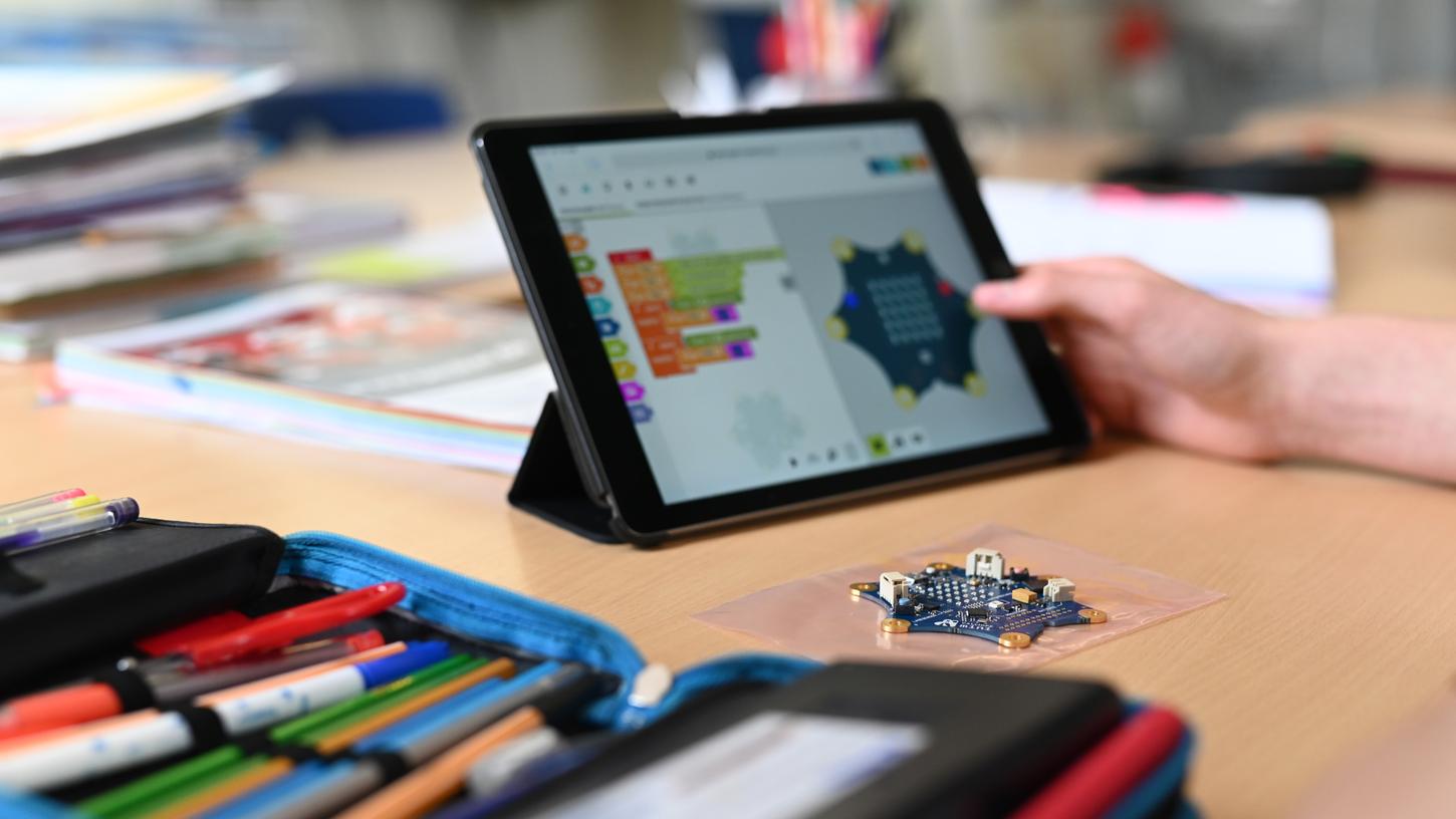 Ein Schüler einer zehnten Klasse programmiert mit seinem Tablet den Einplatinencomputer "Calliope mini".