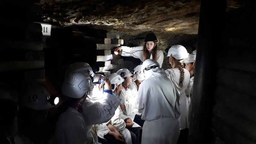 In den Stollen, in denen einst Silber geschürft wurde, geht es eng zu. Die Besucher sind mit Grubenlampen auf ihren Helmen ausgerüstet.