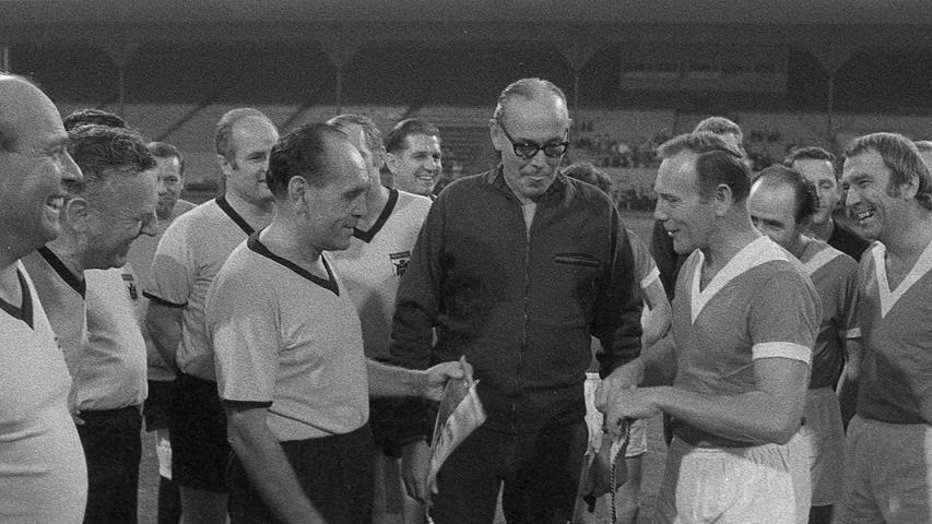 Vor dem Spielbeginn der Wimpelaustausch zwischen den Kapitänen Fritz Schneller aus München (links) und Edi Kernstock (rechts), beide SPD. In der Mitte Schiedsrichter Georg Kennemann.  Hier geht es zum Artikel vom 6. Oktober 1969: Kleine Koalition stürmte