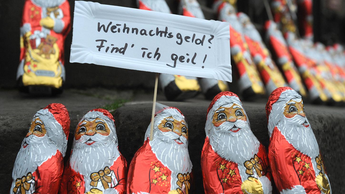 Demonstranten in Bremen haben Schoko-Weihnachtsmänner mit "Transparenten" ausgestattet und aufgestellt.