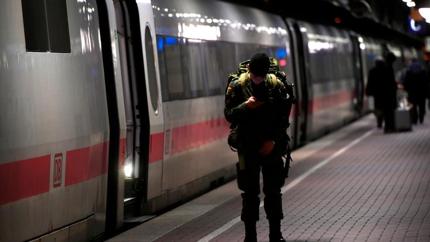 A soldat checks his mobile phone at the main railway station after trains have been cancelled because of the forecasted heavy storm 'Sabine' in Dortmund, western Germany on February 9, 2020. - Germany hunkered down on February 09 and 10, 2020 for a powerful storm expected to disrupt air, rail and sea links, cancel sports events, cut electrical power and damage property. With howling winds and driving rain, forecasters said Ciara would also hit France, Belgium, the Netherlands, Switzerland and Britain. (Photo by Ina FASSBENDER / AFP)