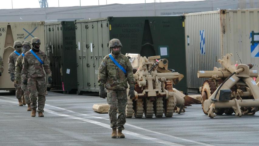Military personnel take part in the unloading operation of US military equipment of the 2nd Brigade Combat Team, 3rd Infantry Division, ahead of the Defender 2020 international military exercises at the Port of Bremerhaven on February 21, 2020. - Exercise DEFENDER-Europe 20 is a US-led multinational exercise, including NATO's participation, that will involve 37,000 troops and take place in countries including Germany, Poland, Lithuania and Estonia in the spring of 2020. (Photo by Patrik Stollarz / AFP)